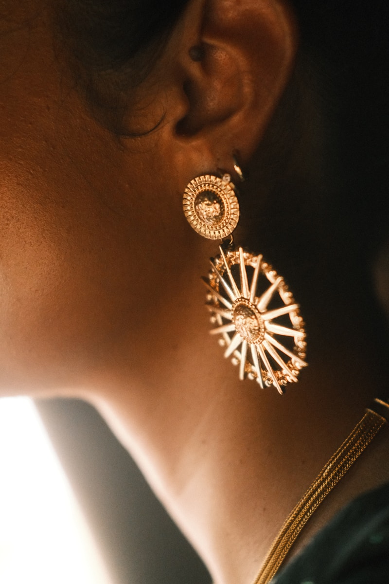 A close up of a person wearing a pair of earrings