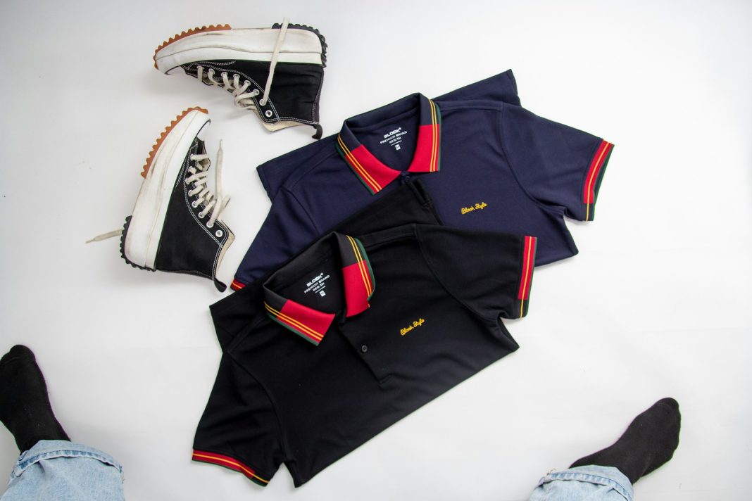 a pair of shoes and a polo shirt on a white surface