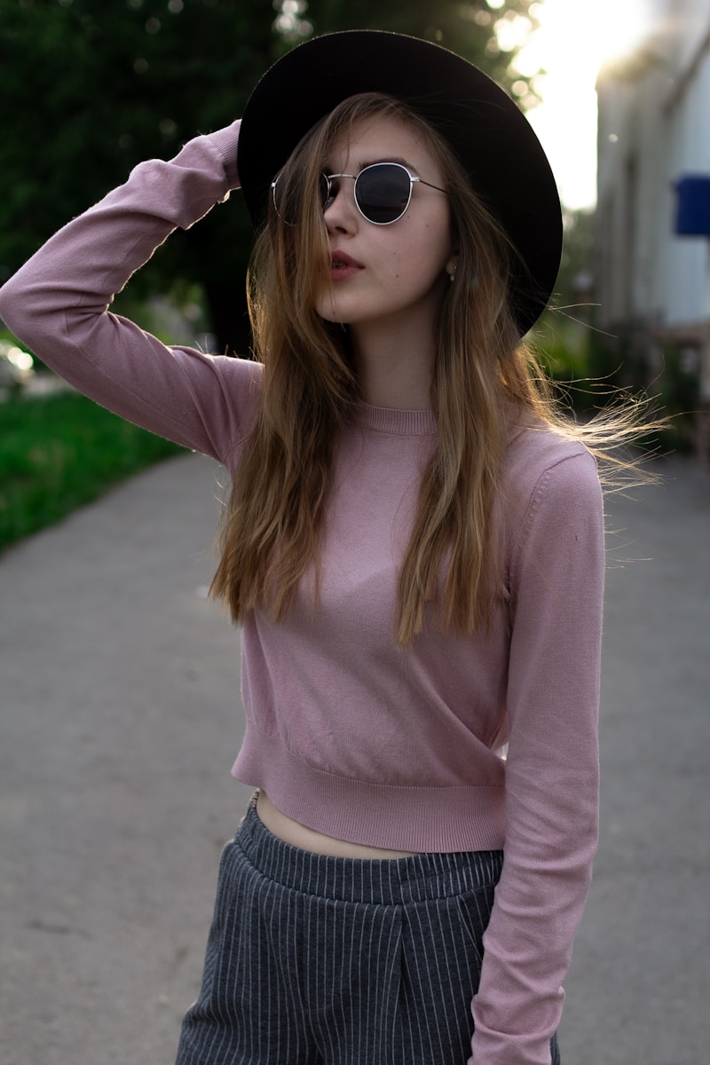 Young woman in hat and sunglasses
