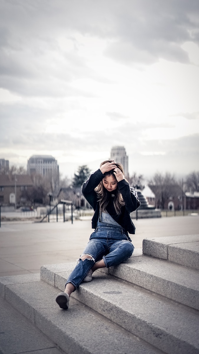 woman sitting on concrete steps