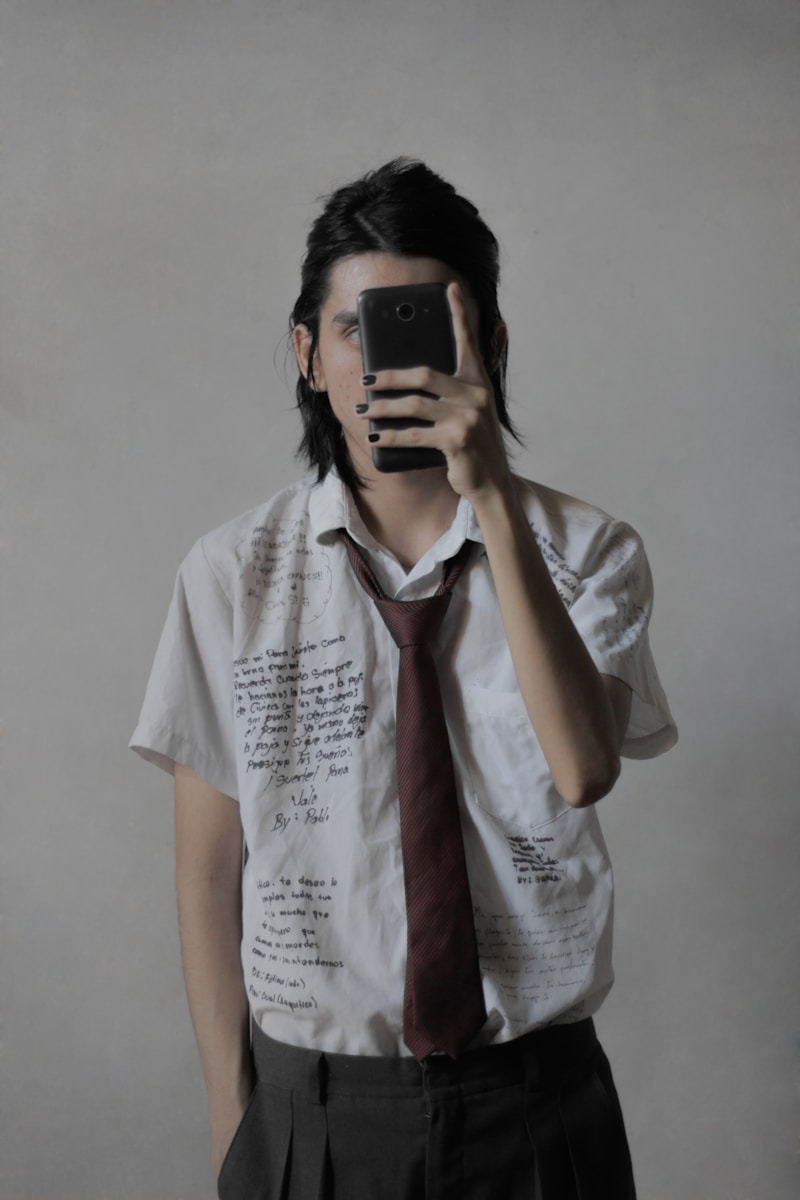 a man taking a picture of himself with a cell phone